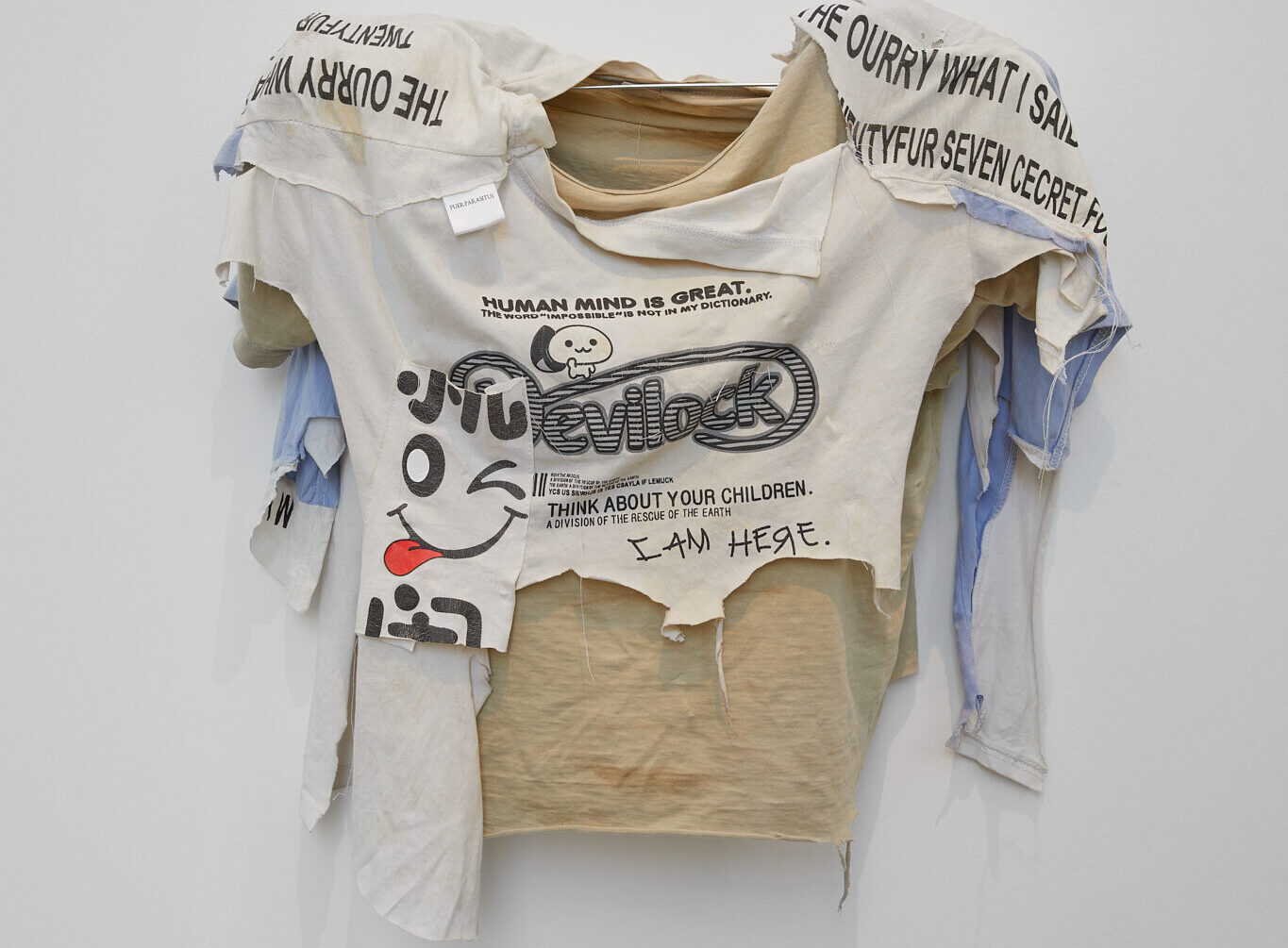 Blouse with draping, hanging on a hanger.