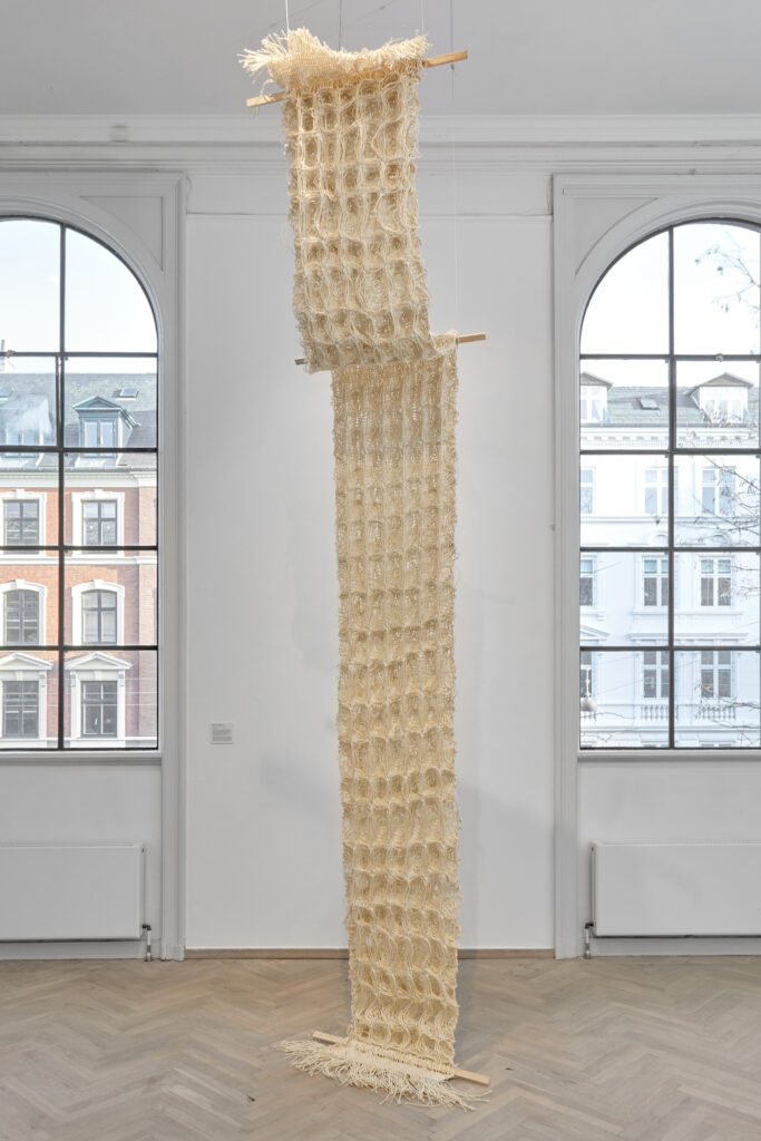 Fabric-like material, hanging from the ceiling.