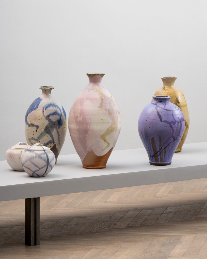 Colorful vases on a podium.