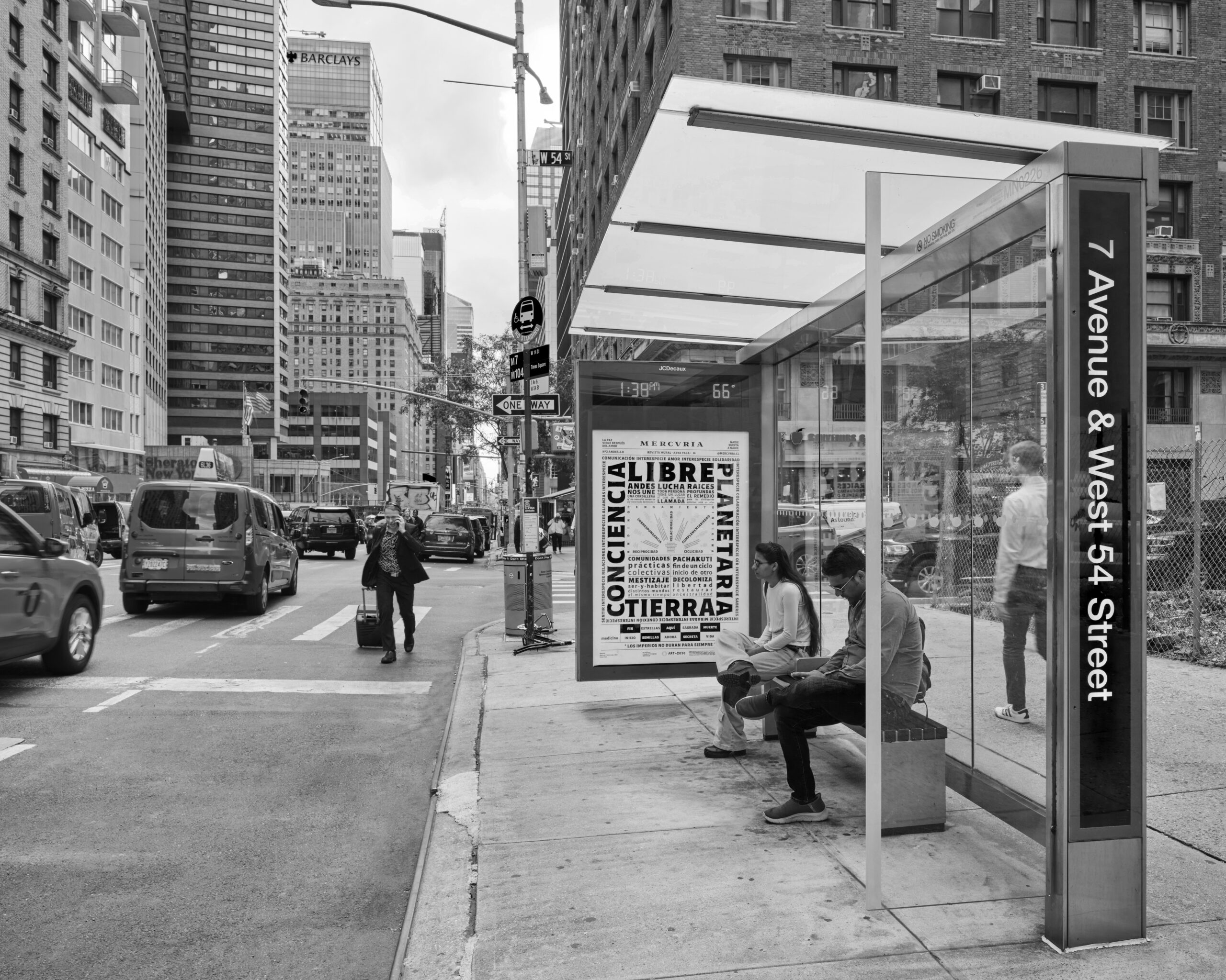 Three abribus' with art posters, placed on a pedestrian street.