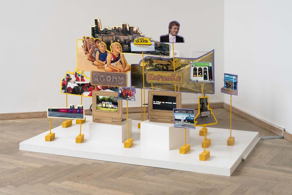 An artwork consisting of various cutout images on a podium.