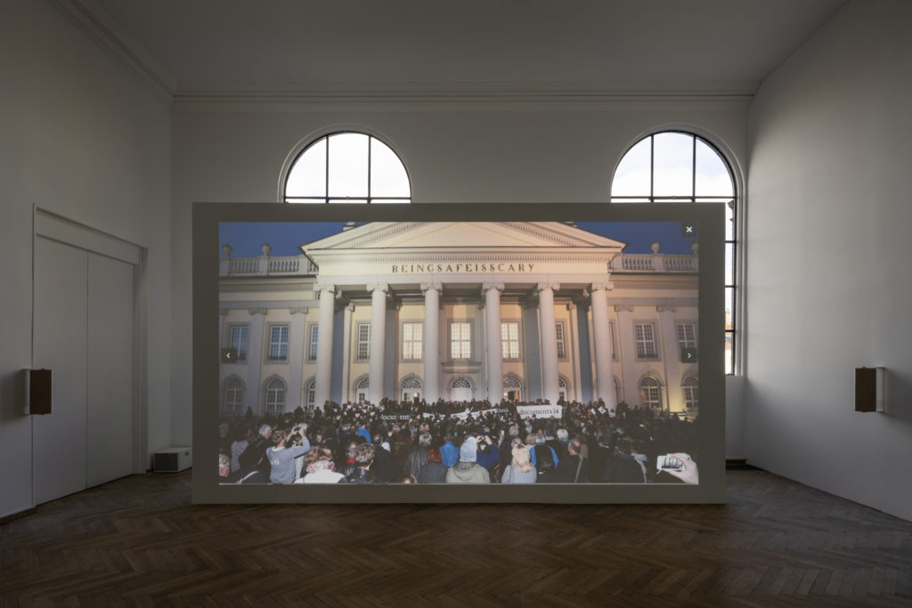 Film screening in an exhibition room.