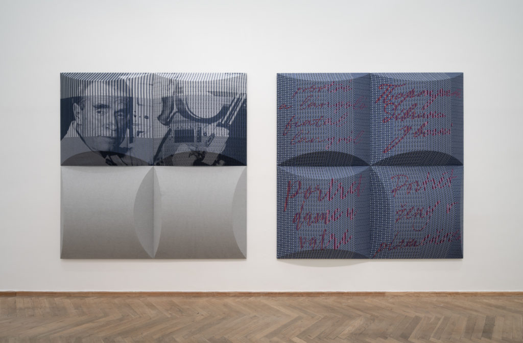 A textile artwork hanging on a wall.