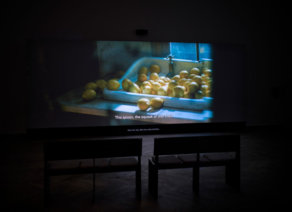 A film is shown in an exhibition space.